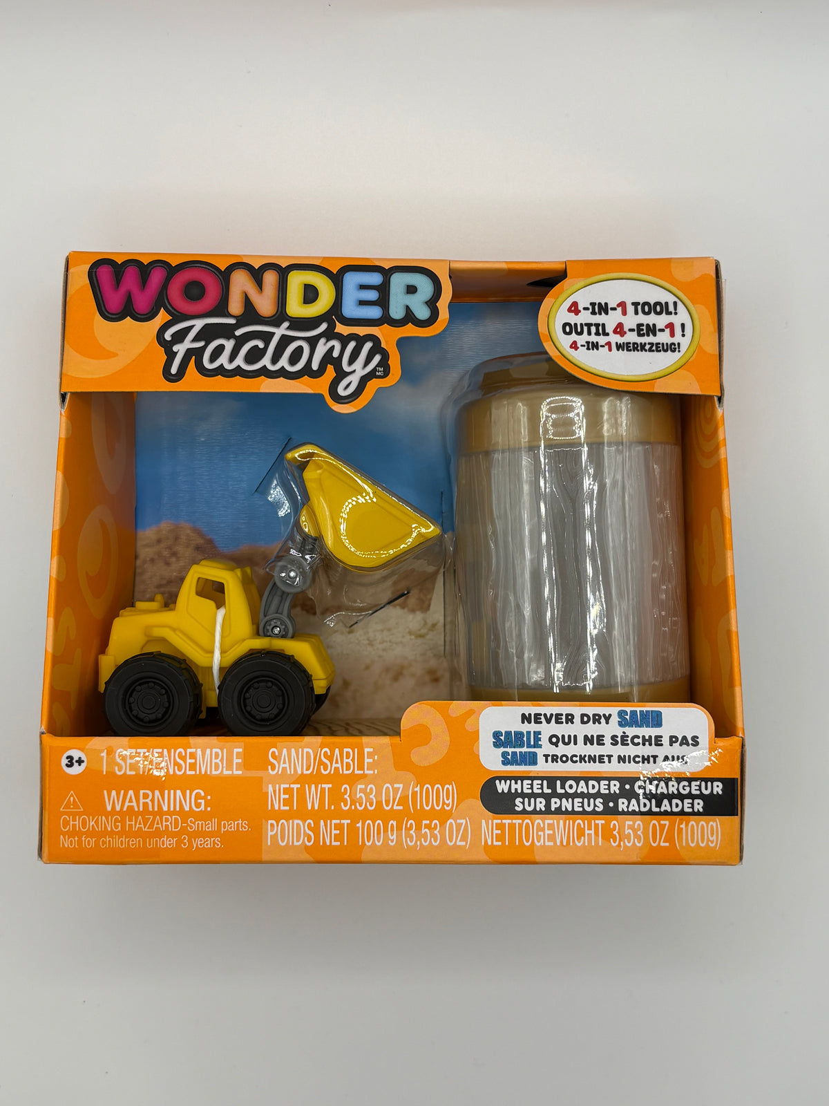 Wonder Factory Sand Sage toy set in its original orange and white packaging, featuring a yellow wheel loader and a clear cylindrical container filled with sand.