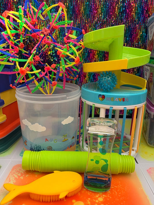 Colorful children's toys on a multicolored surface